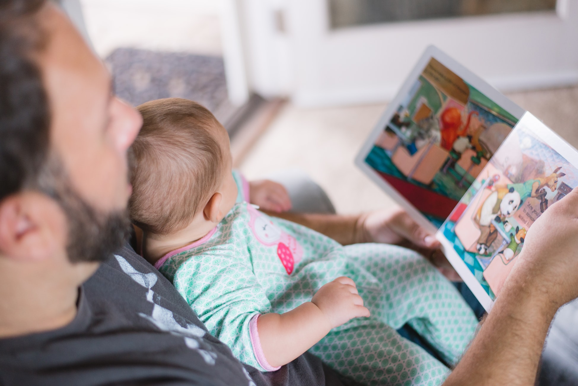 A father reading to his young child